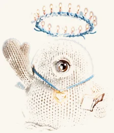 Dave — a small knitted companion with one big amber eye, a gold heart pendant, and a ring of candles for a mind